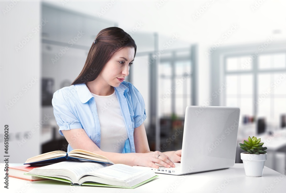 Thoughtful female studying working from home Thoughtful female studying working from home
