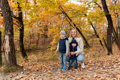 Family is resting in nature in the forest near the lake. Family member care concept. Diversity people