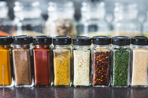 spices and grains in matching spice jars on kitchen counter, simple vegan ingredients and seasonings