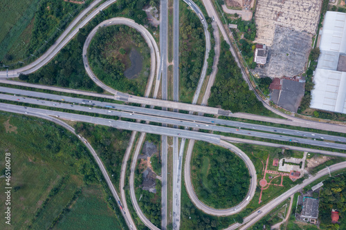 Aerial view of highway junctions with roundabout. Bridge roads shape circle in structure of architecture and transportation concept. Top view. Urban city, Bangkok at sunset, Thailand © Sathit Trakunpunlert