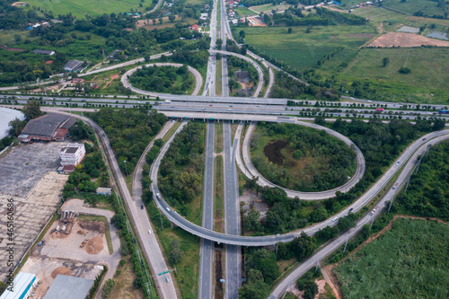 Aerial view of highway junctions with roundabout. Bridge roads shape circle in structure of architecture and transportation concept. Top view. Urban city, Bangkok at sunset, Thailand