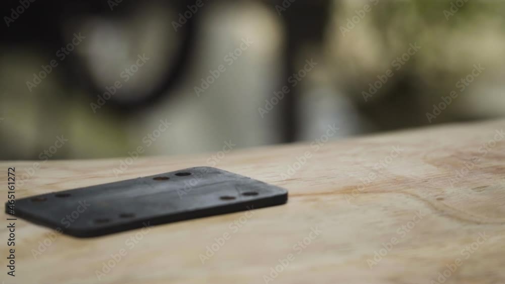 Descending close-up of a base of skateboard. Slow motion Descending close-up of a base of skateboard. Slow motion