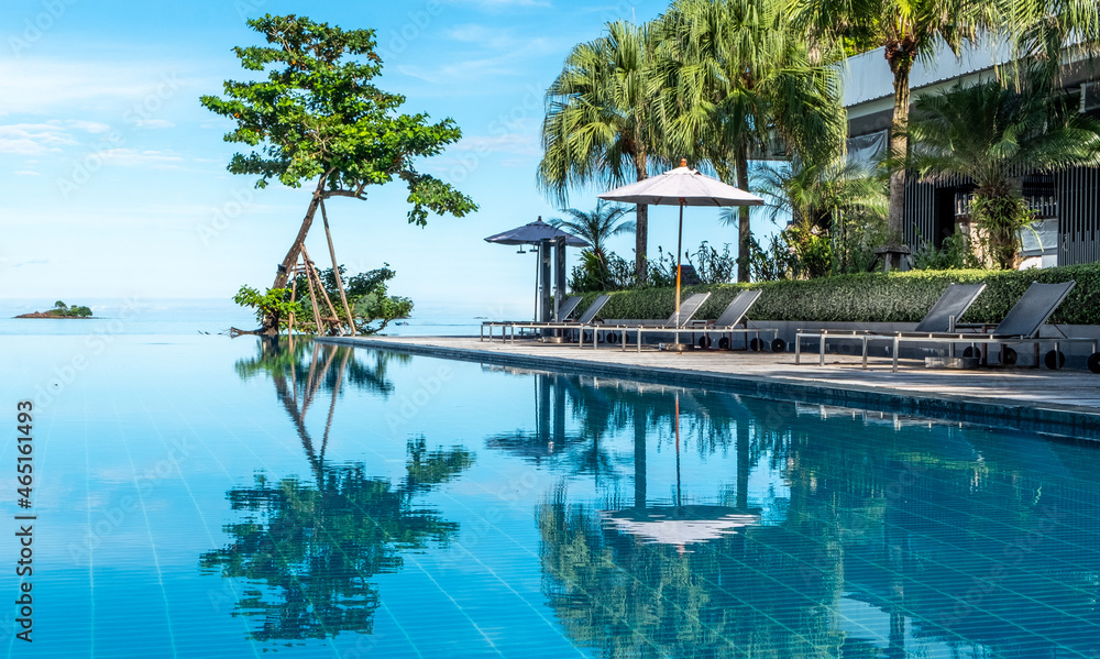 Reflections in an infinity pool at a tropical resort
