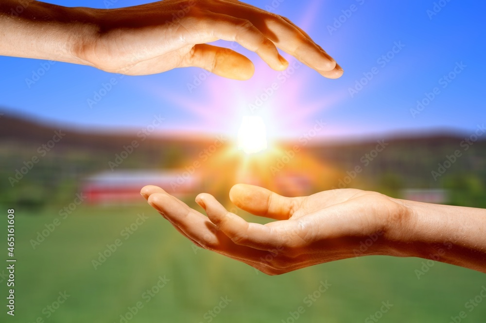 young woman raising hands praying at sunset light young woman raising hands praying at sunset light