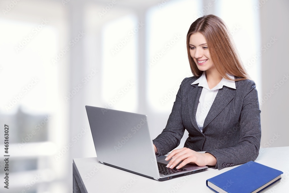 A beautiful female student is studying in college remotely. A beautiful female student is studying in college remotely.