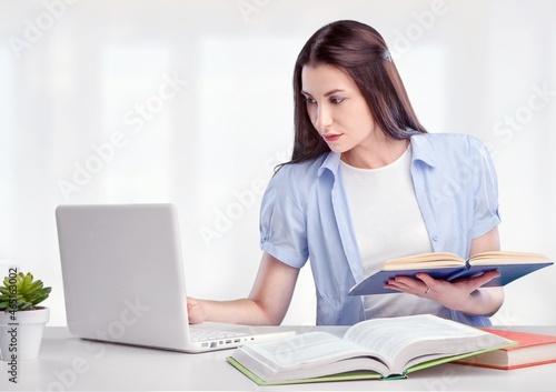 A beautiful female student is studying in college remotely. © BillionPhotos.com