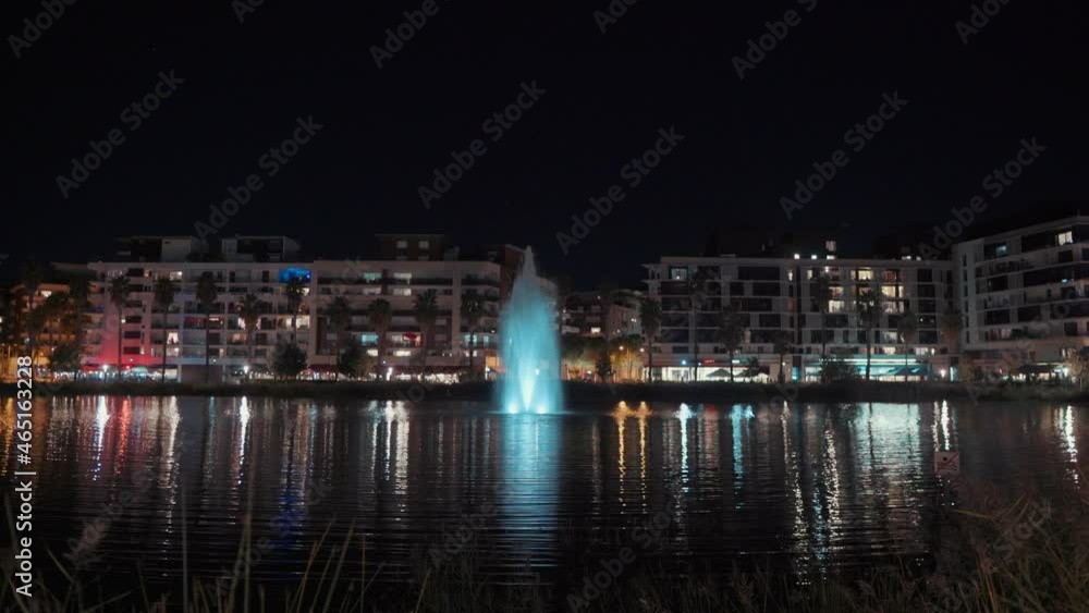 shot from the meadow: a fountain in the center of the restaurants at night, Montpellier - France shot from the meadow: a fountain in the center of the restaurants at night, Montpellier - France