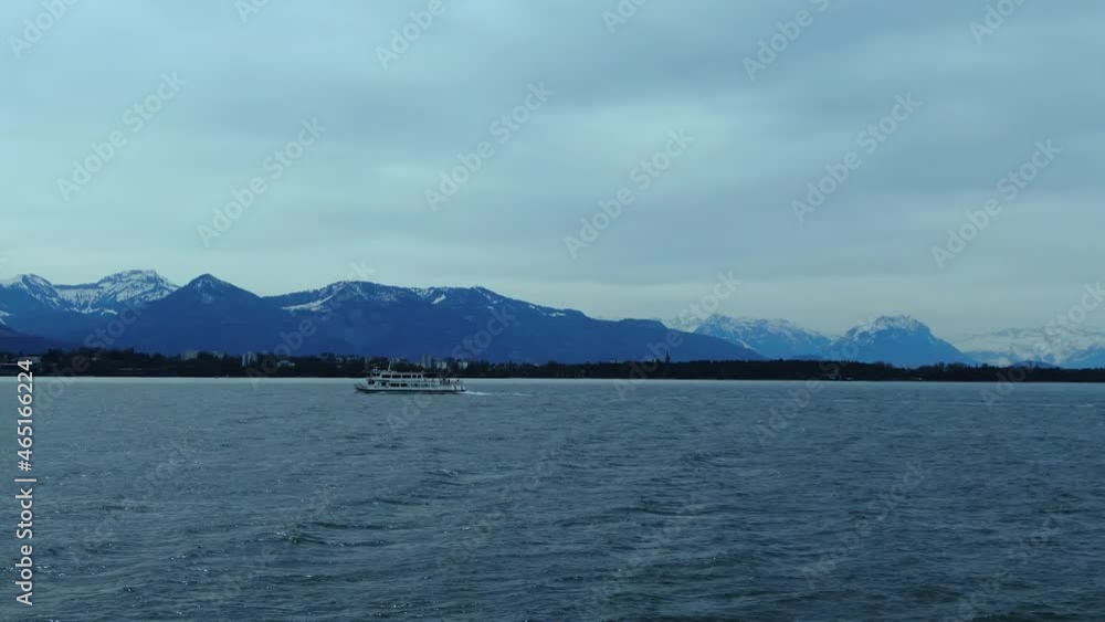 A ferry sailing across a windy lake constance with the alps in the background A ferry sailing across a windy lake constance with the alps in the background