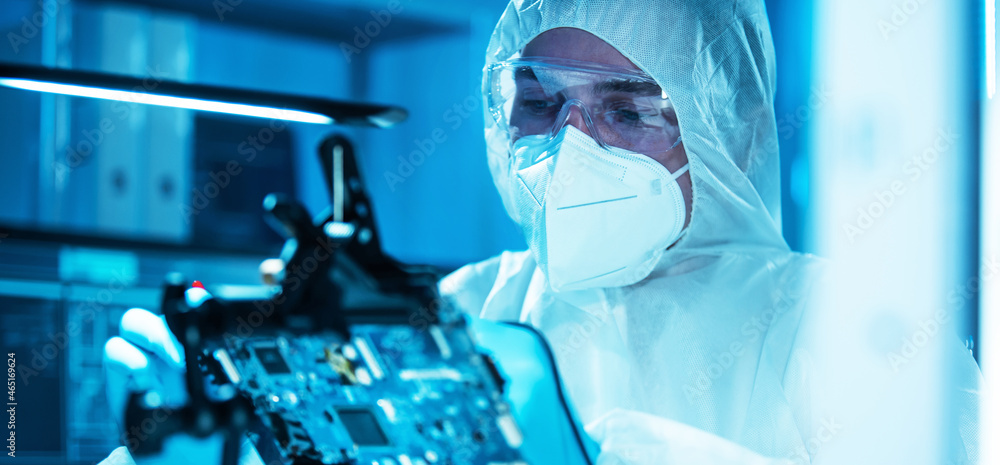 The scientist works in a modern scientific laboratory for the research and development of microelectronics and processors. Microprocessor manufacturing worker uses computer technology and equipment. The scientist works in a modern scientific laboratory for the research and development of microelectronics and processors. Microprocessor manufacturing worker uses computer technology and equipment.