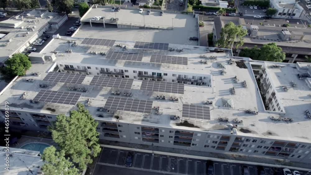 Sherman Oaks Encore apartments building, aerial descending over solar panels on roof Sherman Oaks Encore apartments building, aerial descending over solar panels on roof