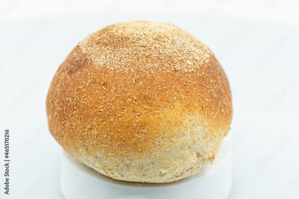 Detailed close up of a fresh baked individual wholemeal bread roll