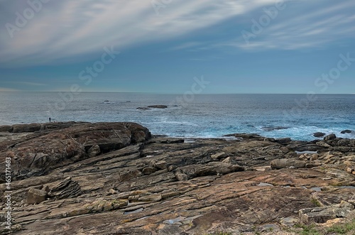 Calm sea scene with rocks in the foreground. Nature landscape