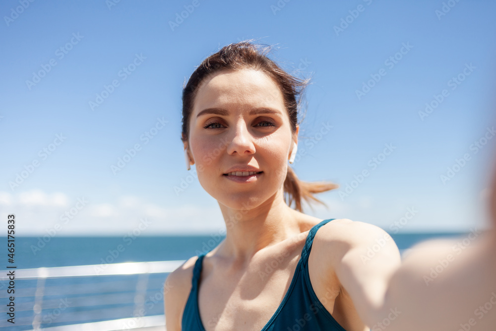 Selfie portrait of an attractive woman jogging on a bright sunny embankment Selfie portrait of an attractive woman jogging on a bright sunny embankment