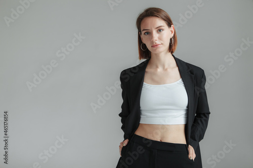Fashion shot of stylish vogue woman in black suit in studio photo
