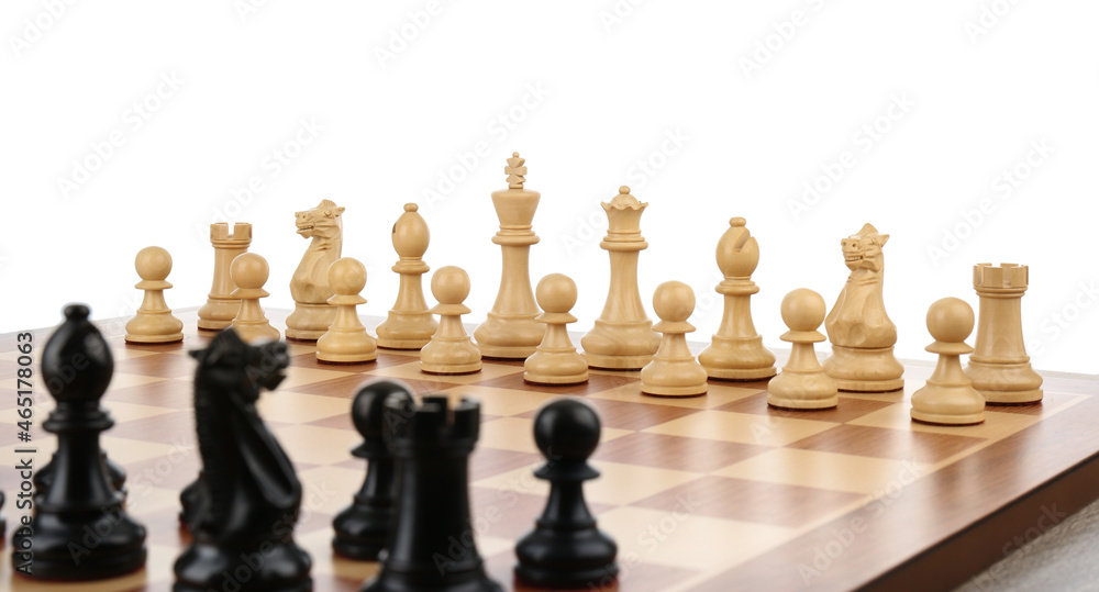 Set of chess pieces on wooden board against white background Set of chess pieces on wooden board against white background