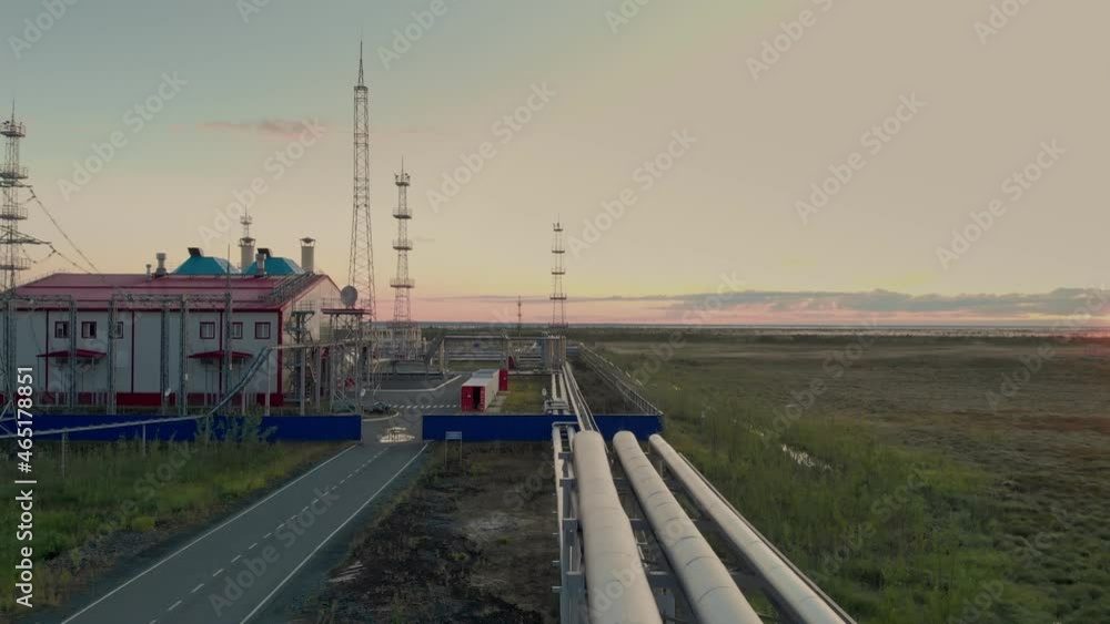 The drone flies over a gas pipeline that powers a gas turbine power plant. Oil and gas industry at the decline of production. Dawn over an oil and gas field. The drone flies over a gas pipeline that powers a gas turbine power plant. Oil and gas industry at the decline of production. Dawn over an oil and gas field.