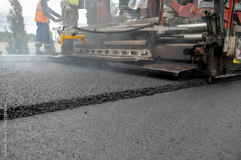 Laying the next layer of asphalt in the construction of a new road Tavrida in the Crimea. The crossing of roads is equipped with safe bridge crossings. Special machinery Laying the next layer of asphalt in the construction of a new road Tavrida in the Crimea. The crossing of roads is equipped with safe bridge crossings. Special machinery