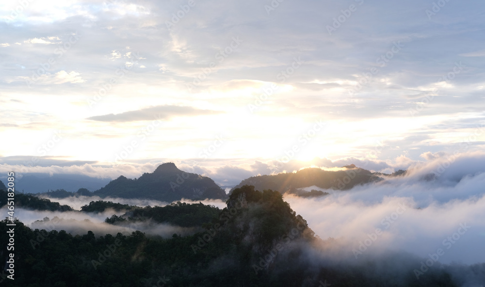 Beautiful mountain sunrise with sunlight and fog over northern Thailand's mountains