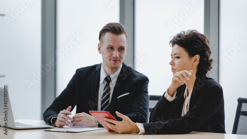 Executive caucasian manager laugh and smile as enjoy business talking together with happy colleauge woman during relax for discussion and consult about joyful teamwork at corporate office photo