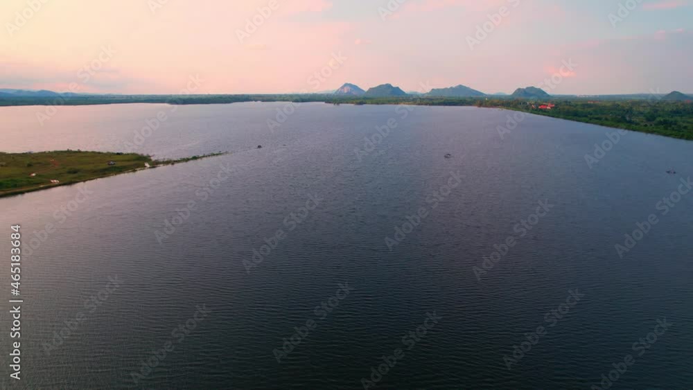 4K Aerial view drone fly over Water reservoir in the countryside of Thailand. Blue sky with clouds and sun, Clouds at Sunrise.
4K Aerial view drone fly over Water reservoir in the countryside of Thailand. Blue sky with clouds and sun, Clouds at Sunrise.