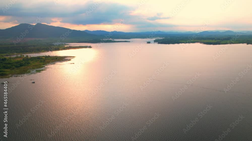 4K Aerial view drone fly over Water reservoir in the countryside of Thailand. Blue sky with clouds and sun, Clouds at Sunrise.
4K Aerial view drone fly over Water reservoir in the countryside of Thailand. Blue sky with clouds and sun, Clouds at Sunrise.