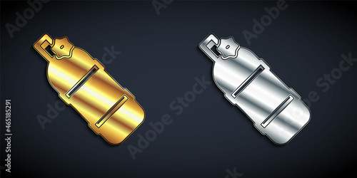 Gold and silver Aqualung icon isolated on black background. Oxygen tank for diver. Diving equipment. Extreme sport. Diving underwater equipment. Long shadow style. Vector