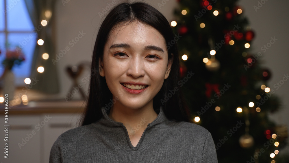 Winter Christmas holidays concept. young beautiful happy asian korean lady face camera smiling by blurred view of decorated new year trees. elegant girl looking lens with joyful mood Winter Christmas holidays concept. young beautiful happy asian korean lady face camera smiling by blurred view of decorated new year trees. elegant girl looking lens with joyful mood