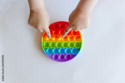 Baby playing with pop it toy, anti-stress toy, Tactile Soothing toy balls with Simple dimple close-up