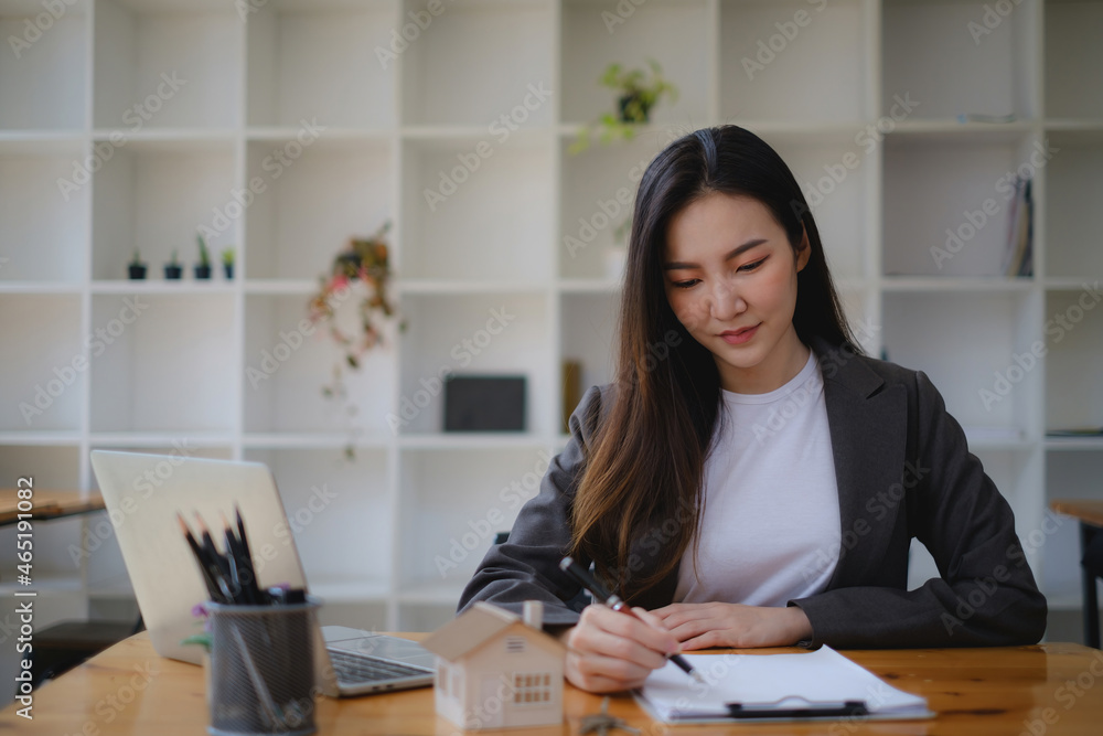 Close up of Business woman checking document before signing agreement for buying house. Bank manager and real estate concept. Close up of Business woman checking document before signing agreement for buying house. Bank manager and real estate concept.