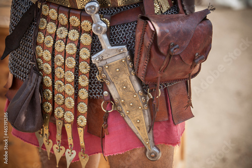 Fotografija Centurion girding a pugio, a dagger used by roman soldiers as a sidearm