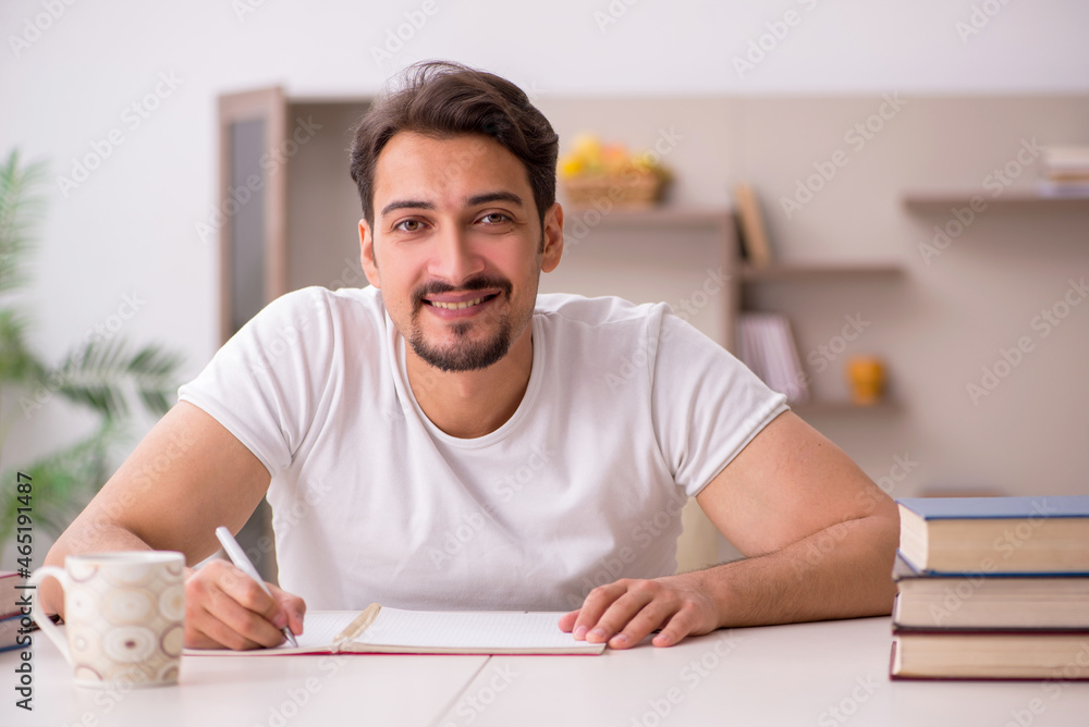 Young male student studying at home during pandemic Young male student studying at home during pandemic
