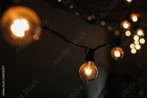 photo of a garland of light bulbs on a dark background. selective focus. christmas and new year concept 