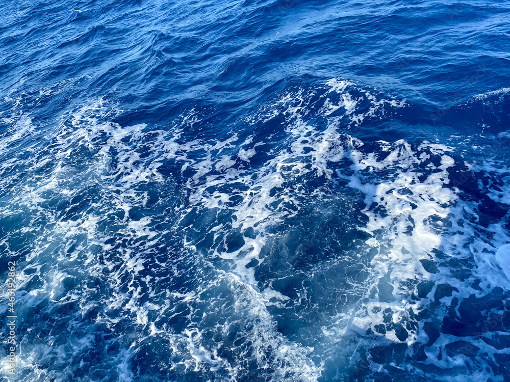 Aerial view to ocean waves. Blue water background Aerial view to ocean waves. Blue water background