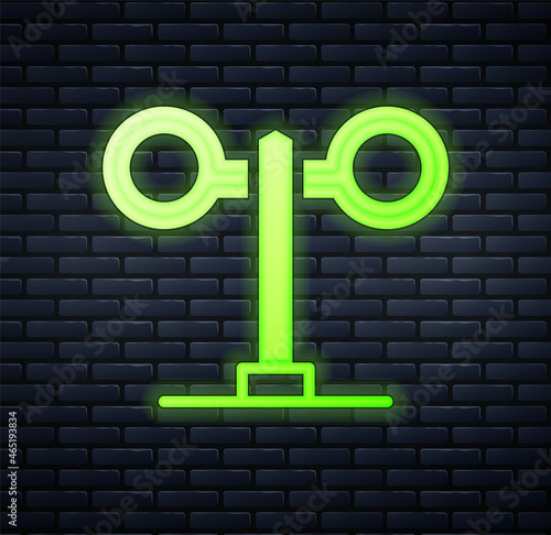 Glowing neon Train traffic light icon isolated on brick wall background. Traffic lights for the railway to regulate the movement of trains. Vector