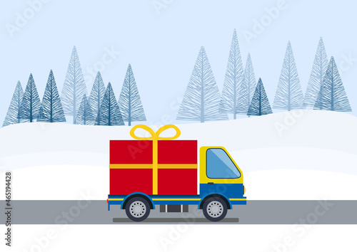 Christmas shopping. Big gift packages on a truck on the road to deliver the box on winter landscape.