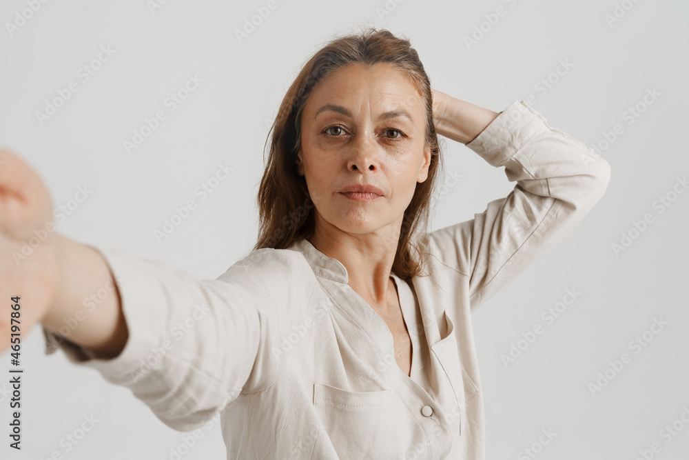 European ginger woman looking at camera while taking selfie photo European ginger woman looking at camera while taking selfie photo