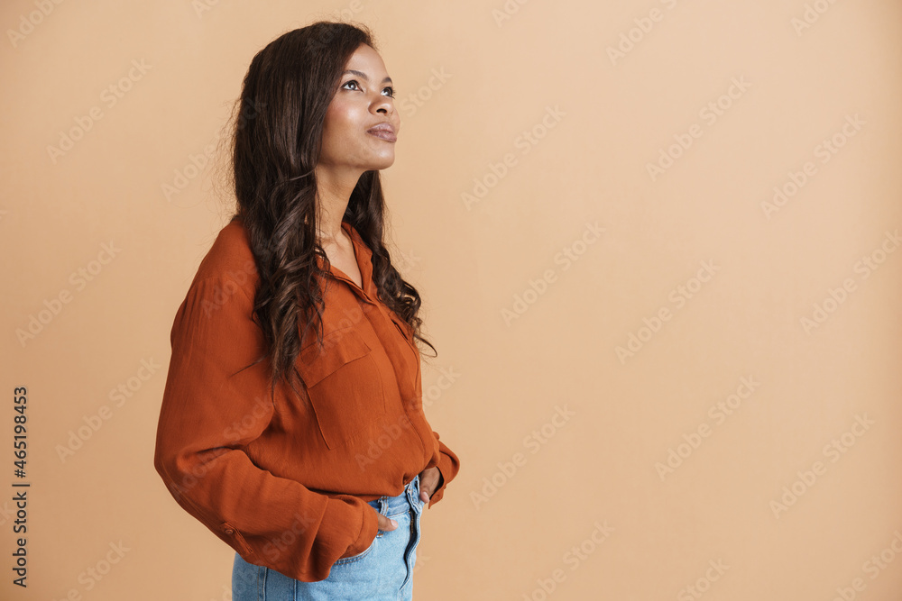 Young black woman wearing shirt posing and looking upward Young black woman wearing shirt posing and looking upward