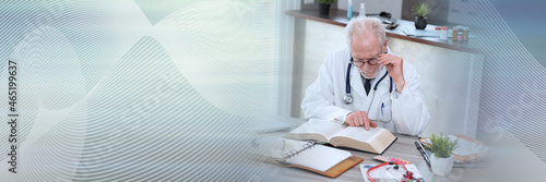 Doctor reading a textbook; panoramic banner