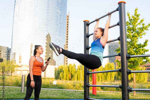 Tableau sur toile two female athletes train outdoors, calisthenic exercises and natural training,