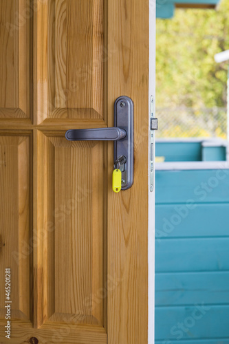 open door with key in lock, door handle photo