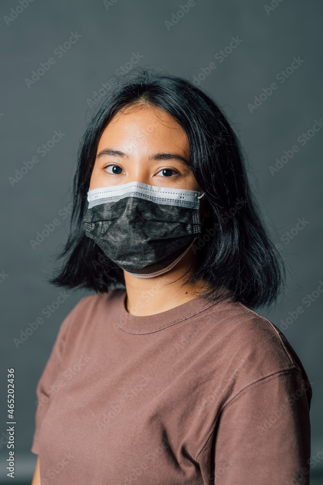 Young woman wearing protective face mask during pandemic Young woman wearing protective face mask during pandemic