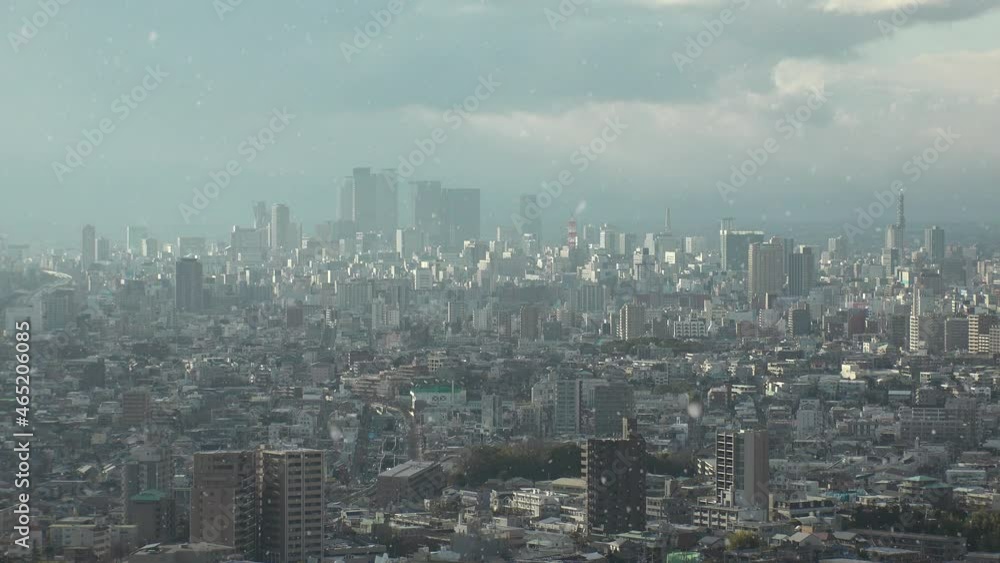 NAGOYA, JAPAN : Aerial high angle view of cityscape of Nagoya and falling snow. View of buildings around Nagoya station. Japanese winter and romantic Christmas season concept. Sunset or sunrise shot. NAGOYA, JAPAN : Aerial high angle view of cityscape of Nagoya and falling snow. View of buildings around Nagoya station. Japanese winter and romantic Christmas season concept. Sunset or sunrise shot.