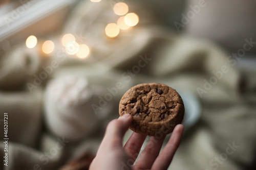 hand holding a homemade chocolate chip cookie photo