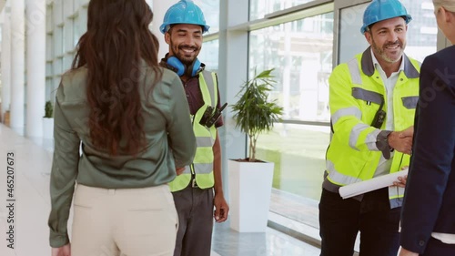 Manual workers and architects meeting at construction site