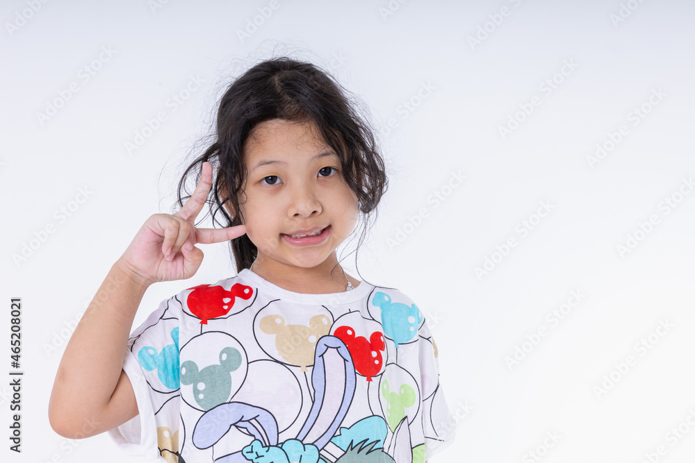 Portrait Asian kid girl she nice-looking cute attractive healthy. Make v-sign good mood isolated on white background in studio shot with copy space. Portrait Asian kid girl she nice-looking cute attractive healthy. Make v-sign good mood isolated on white background in studio shot with copy space.