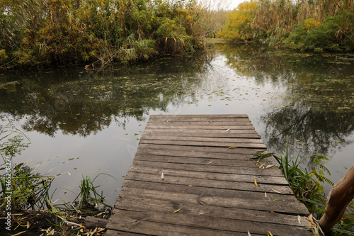 Beautiful wooden pier and lake on autumn day