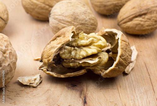 Crushed Walnut on the wood background. Close up.