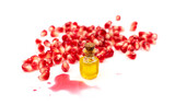 Pomegranate Oil and Seeds Isolated on White Background