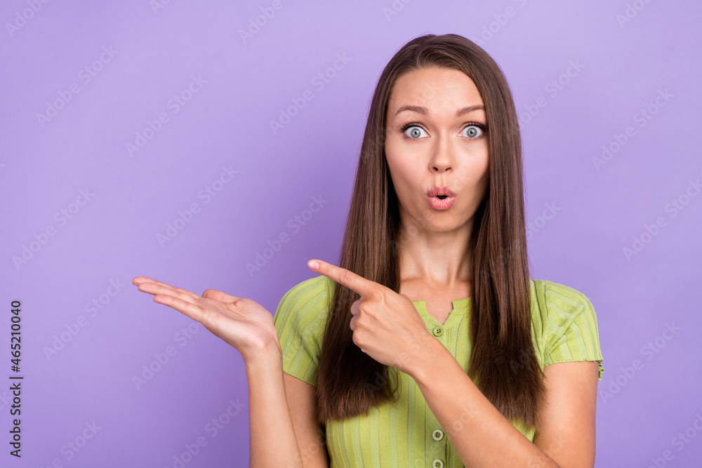 Portrait of attractive stunned girl holding on palm copy empty space ad advert isolated over purple violet color background Portrait of attractive stunned girl holding on palm copy empty space ad advert isolated over purple violet color background
