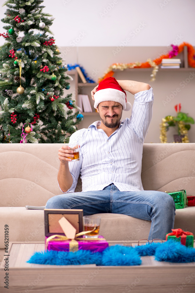 Young man celebrating Christmas at home alone Young man celebrating Christmas at home alone